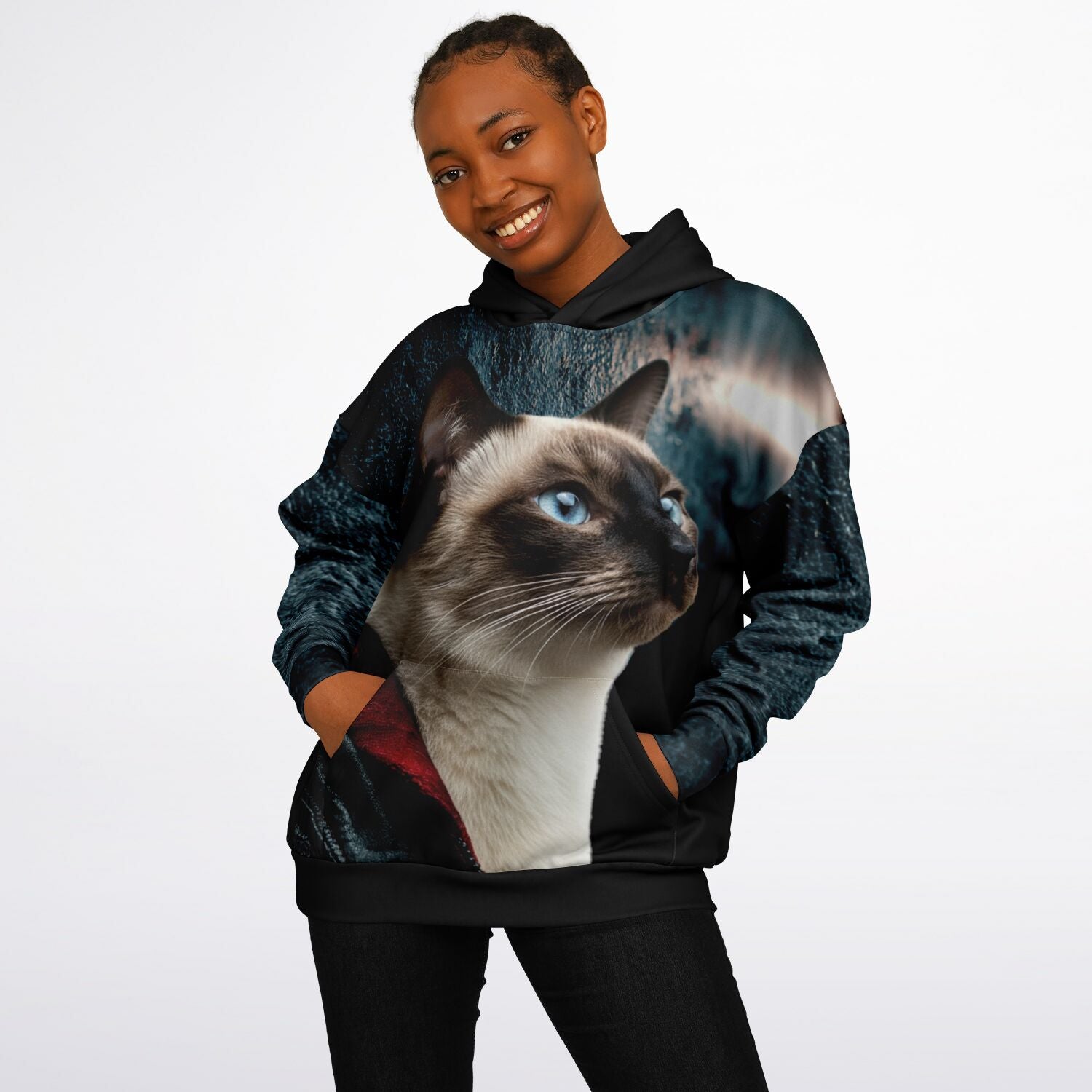Person wearing a hoodie with a cat design on a plain background