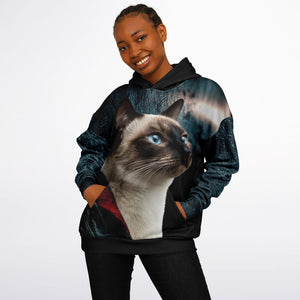 Person wearing a hoodie with a cat design on a plain background