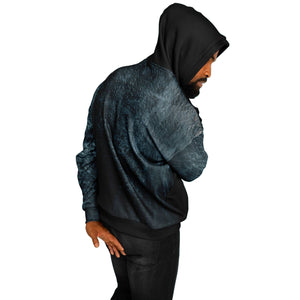 Person wearing a dark hoodie and pants on a white background