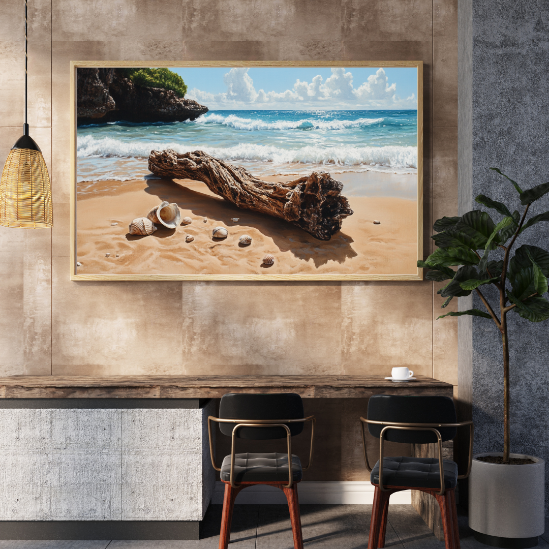 Framed beach wall art featuring driftwood and seashells on golden sand, displayed in a modern coastal-themed interior with warm tones and minimalist decor