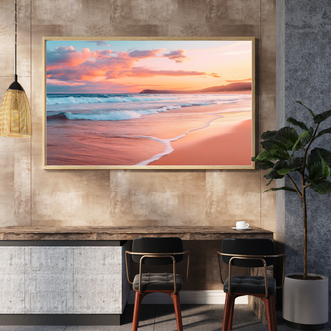 Framed beach sunset digital print with soft pink skies and rolling waves displayed in a modern dining nook with earthy tones and coastal decor