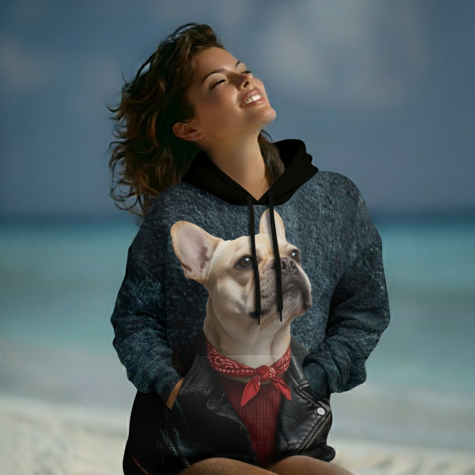 Person wearing a hoodie with a dog design on a beach
