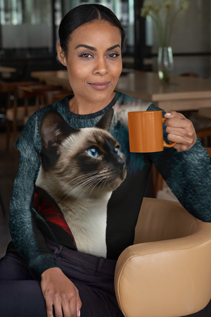 Woman holding a mug with a Siamese cat on her lap in a restaurant setting